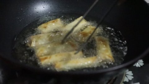 Traditional Russian crepe with meat frying in a roaster