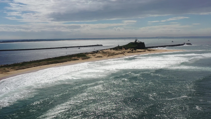 Nobbys head and beach in Newcastle city of Australia – aerial around 4k.
