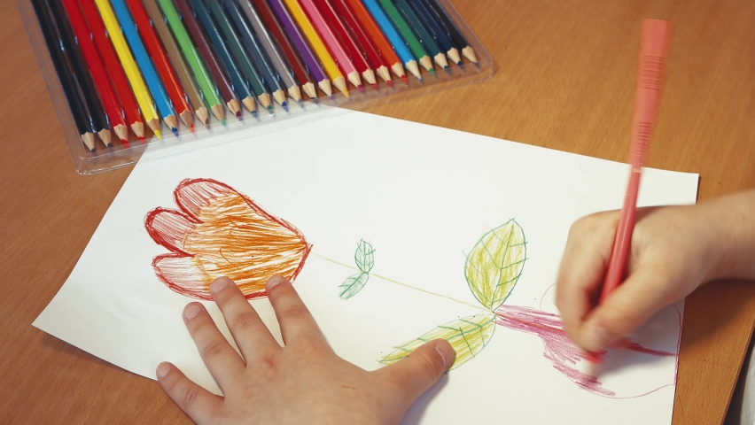 Children's hands draw a symbolic flower in a vase with a pencil close-up. The concept of children's creativity, online education. Leisure of a happy child, quarantine and isolation. View from above. Royalty-Free Stock Footage #1071351538