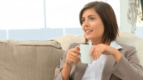 Brunette drinking a cup of tea at home