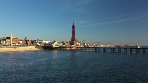4K: Aerial Drone Video of The Blackpool Tower, England, UK. Flying low over the sea towards the pier. Stock Video Clip Footage
