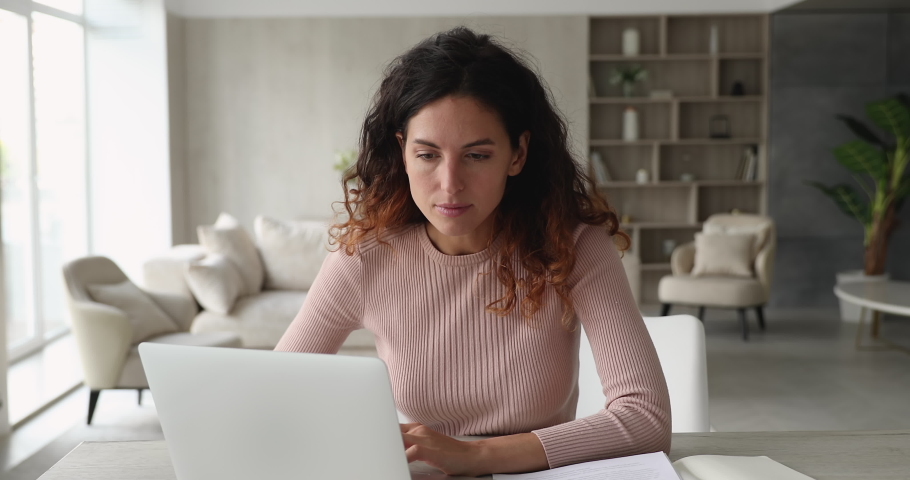 Woman sit at desk use laptop read unpleasant e-mail feels stressed. Upset female experience problems with computer, system failure, backup issue, lost important information, need device repair concept Royalty-Free Stock Footage #1071353896