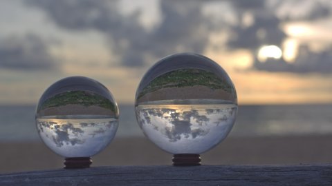
time lapse sunset over sea in crystal ball place on timber beside the beach video 4K. 
Nature video High quality footage time lapse day to night in nature and travel concept.
