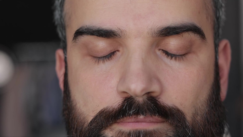 Close up of male face. Attractive man opening his beautiful brown eyes with long eyelashes. Highly detailed portrait of human face. Royalty-Free Stock Footage #1071361042