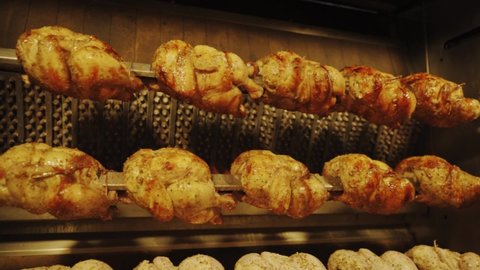 Chicken On The Turning Spit With Tasty Golden-yellow Roasted Skin In Four Rows - slow motion