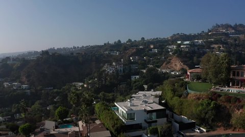 Low aerial shot of Beverly Hills mansions littering the hillside. 4K