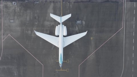 Gulfstream G550 standing inactive on grey tarmac of airfield, aerial