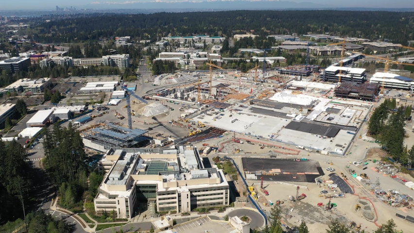 Cinematic aerial drone footage of cranes at the development of the new campus at the Microsoft Corporate Headquarters, Microsoft Commons, Microsoft Studio in Overlake and Redmond, Washington, Seattle