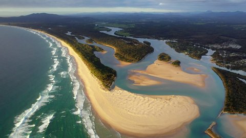 Wide revealing drone shot of Foster beach, the Nambucca River and ocean at Nambucca Heads New South Wales Australia