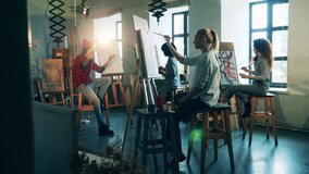 Art school with a group of women learning how to paint. Art education concept. - Powered by Shutterstock - Get 15% off with code: PIKWIZARD15