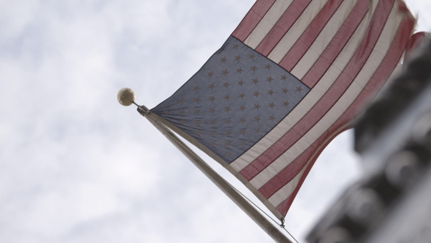 Ripped American Flag Waving in the Wind 