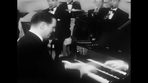 CIRCA 1950s - A big band performance in a formal ballroom in this 1950s soundie musical.