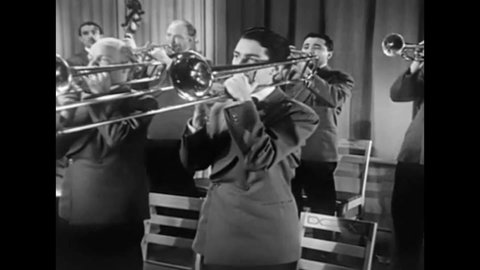 CIRCA 1940s - A crooner sings in a ballroom in this big band soundie 1940s musical.