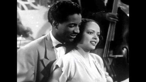 CIRCA 1940s - An African American jazz quartet plays while a man and woman dance in this 1940s soundie musical.