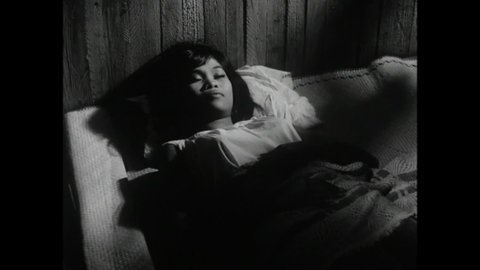 CIRCA 1965 - In this horror film, a woman gets in bed and then discovers a disfigured murderer in her bedroom.