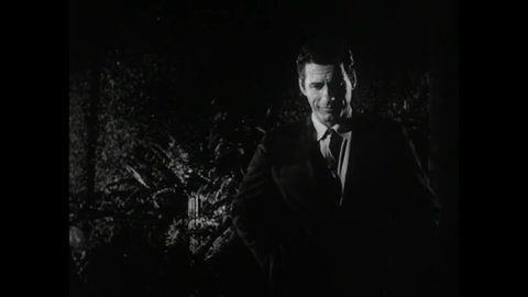 CIRCA 1965 - In this horror film, a woman slaps a man for trying to kiss her by the jungle at night and she drives away.