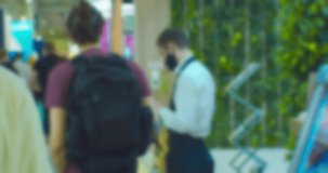 Blurred silhouette of an unrecognizable person with an electronic tablet in his hands.Defocused video.Business background.