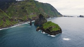 Flying around the famous Ribeira da Janela volcanic sea stacks in the Atlantic ocean in Madeira island, Portugal. 4K UHD video.