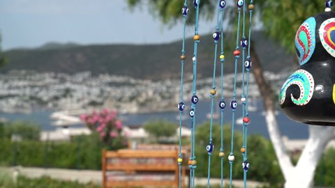 Tree hanging gourd, beaded ornaments and blurred touristic Bodrum district in the background. Muğla TURKEY