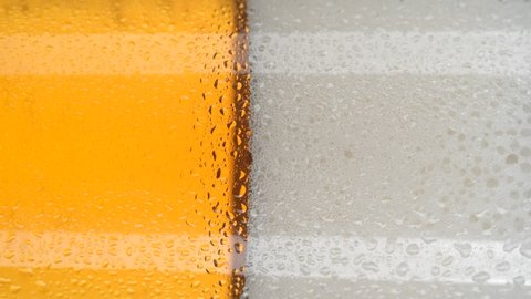 beer in glass close up and rotation. glass of beer with foam. vertical video. 4K UHD video