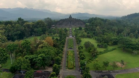 Empty iconic Buddhist temple Borobudur Java Indonesia aerial dolly on cloudy day