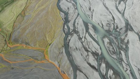 Volcanic minerals give color to melt watering downstream through river delta