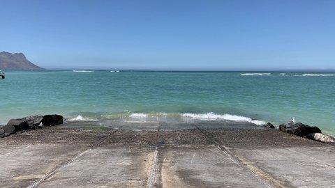 Strand fishing boat concrete slipway into the blue ocean