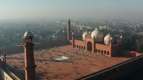 Locals And Tourists Visit Famous Badshahi Mosque On A Sunny Morning In Lahore, Pakistan. - aerial