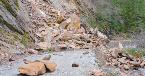 Rockslide over road and river Galbenul, in Gorj county, Romania. Landslide, natural disaster.