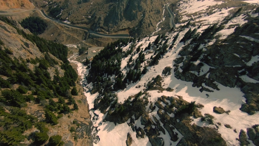 Fast Cinematic Drone Dive in the Mountain Valley With Snow Beams and Pines, Sharp Cliffs and Misty Valley Behing the Mountain in Northern Turkey. Aerial freestyle aerobatic View Shot on FPV racing