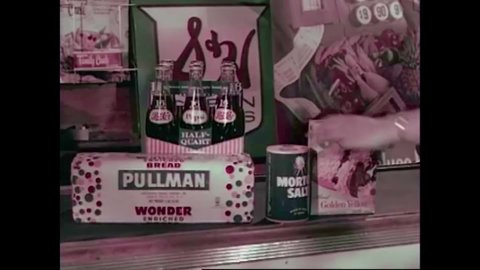 CIRCA 1960s - Items are rung up at a busy supermarket, including someone's baby in the 1960s.