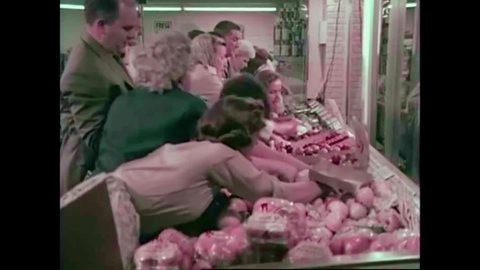 CIRCA 1960s - Customers fight over produce at a grocery store in the 1960s.