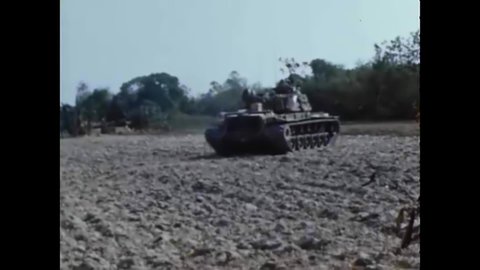 CIRCA 1960s - American soldiers rest in a field with some tanks in Vietnam in 1968.