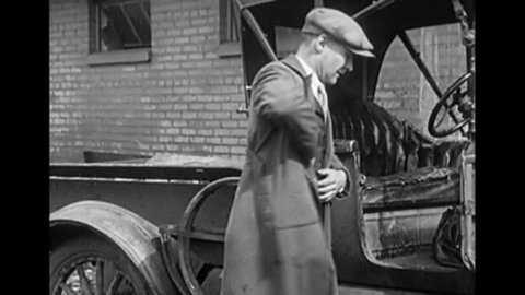 CIRCA 1920s - A repair man arrives late to a job because he has a flat tire in the 1920s.
