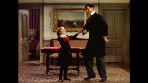 CIRCA 1939 - In this musical, a little girl (Shirley Temple) dances and sings in a cockney accent with her butler.