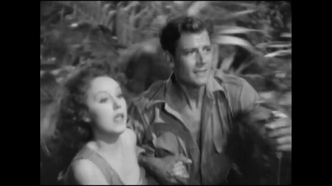 CIRCA 1932 - In this adventure movie, a couple is pursued by a man-killing hunter through an island jungle.