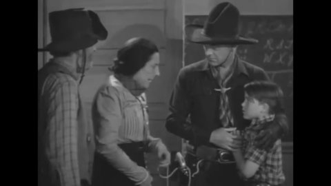CIRCA 1938 - In this western film, Hopalong Cassidy spanks a schoolboy who locked his teacher in the closet and put horseshoes in his back pockets.