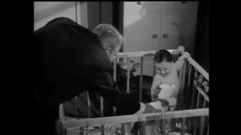 CIRCA 1951 - In this comedy movie, a montage shows a man (Spencer Tracy) devoted to his baby grandson and the infant's christening.