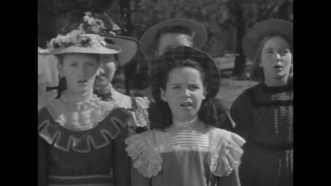 CIRCA 1938 - Hopalong Cassidy and his friends attend a flag-raising ceremony where children sing a patriotic song before leading the pledge.