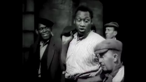 CIRCA 1936 - In this musical, a dockworker (Paul Robeson) sings about the Biblical story of Jericho on his way to work.