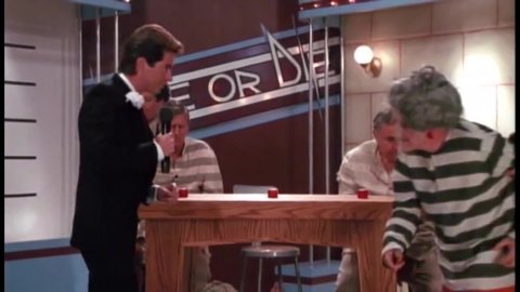 CIRCA 1987 - In this horror comedy, death row convicts participate in a trivia game show and one is electrocuted to death by his buzzer.