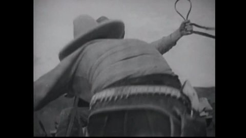 CIRCA 1934 - A cowboy (John Wayne) throws an explosive behind his stagecoach to create a roadblock, separating them from a posse on their tail.