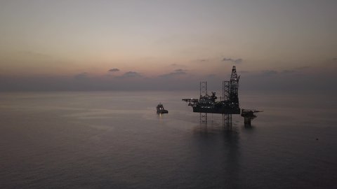 Aerial view of offshore drilling rig during sunrise - oil and gas industry
