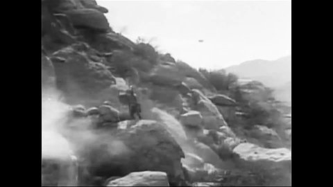 CIRCA 1920 - In this silent period piece, Native Americans and British soldiers fight together along a rocky shore in the French and Indian War.
