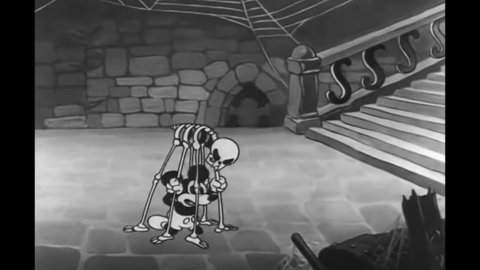 CIRCA 1933 - In this animated film, Mickey Mouse is attacked by skeletons in a haunted house, including a skeletal spider.