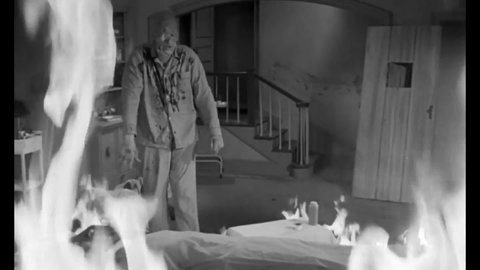 CIRCA 1962 - A disfigured creature attacks an evil scientist and saves a woman from his burning lab, while a disembodied head looks on in horror.