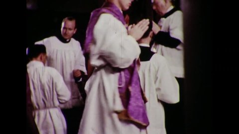 CIRCA 1954 - Seminary students receive the laying on of hands and priestly vestments during their ordination ceremony.