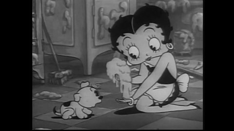 CIRCA 1939 - Betty Boop traps a housefly in a handful of batter so it will stop pestering her puppy Pudgy, but it manages to escape.