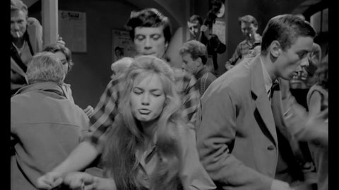 CIRCA 1962 - In this teen movie, teenagers dance to live rock music at an underground club.