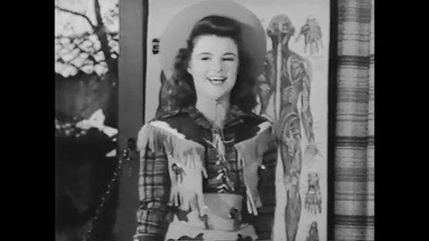 CIRCA 1944 - In this musical, a cowgirl sings to a crowd backed up by a man on a harmonium.